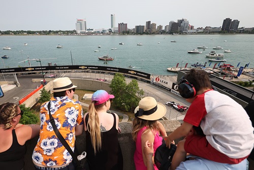 Fans watch cars on track at turn 6 from the rooftop